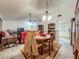 This dining room is attached to the living area and features a wooden table set and wood-look floors at 6901 Arbor Oaks Ct, Bradenton, FL 34209