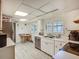 Bright kitchen featuring white cabinets, tile floors, and stainless steel appliances at 6901 Arbor Oaks Ct, Bradenton, FL 34209