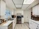 Practical kitchen with white cabinets, tile flooring, and efficient layout at 6901 Arbor Oaks Ct, Bradenton, FL 34209