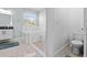 Bright bathroom featuring a soaking tub with marble accents and tile floors at 716 Laurel Ave, Venice, FL 34285