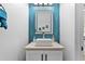 Modern bathroom featuring a vessel sink, quartz countertop, blue geometric tile backsplash, and lighted mirror at 716 Laurel Ave, Venice, FL 34285