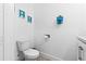 This simple bathroom features a toilet, light fixtures, and a towel rack for added functionality at 716 Laurel Ave, Venice, FL 34285
