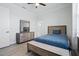 Well lit bedroom featuring hardwood flooring, ceiling fan, neutral walls, and a chest of drawers with mirror at 716 Laurel Ave, Venice, FL 34285
