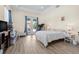 Bright bedroom with tray ceiling, hard wood floors, and double doors leading to the backyard at 716 Laurel Ave, Venice, FL 34285