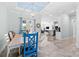 Dining room with an ornate light fixture, tile floors, and dining table with blue and white chairs at 716 Laurel Ave, Venice, FL 34285