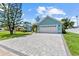 Exterior showcasing a light blue home with a spacious driveway and an attached two-car garage at 716 Laurel Ave, Venice, FL 34285