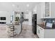 Modern kitchen with an island, sleek black appliances, and white cabinetry for a bright, clean feel at 716 Laurel Ave, Venice, FL 34285