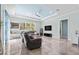 Spacious living room with tile flooring, a tray ceiling, large windows, and a comfortable sofa at 716 Laurel Ave, Venice, FL 34285