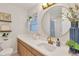 Well-lit bathroom featuring a modern vanity, brushed gold fixtures, and decor at 7210 S Sparkman St, Tampa, FL 33616