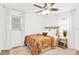 Bright bedroom with neutral walls, ceiling fan, and white curtains and trim at 7210 S Sparkman St, Tampa, FL 33616