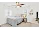 Bright bedroom with neutral walls, ceiling fan, and white curtains and trim at 7210 S Sparkman St, Tampa, FL 33616