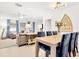 Dining area with modern lighting, seating for six, and a view into the living room at 7210 S Sparkman St, Tampa, FL 33616