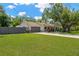 Charming home featuring well-maintained lawn, a large mature shade tree, and an attached two-car garage at 7210 S Sparkman St, Tampa, FL 33616