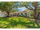 Charming single story home featuring a well-manicured lawn, mature trees, and tasteful landscaping at 7210 S Sparkman St, Tampa, FL 33616