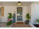 Charming front entrance with decorative door, plants and a welcoming Sunshine mat at 7210 S Sparkman St, Tampa, FL 33616