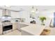 Bright kitchen with white cabinets, stainless steel appliances, and a spacious quartz countertop at 7210 S Sparkman St, Tampa, FL 33616