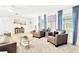 Bright living room featuring neutral decor, seating, and large windows at 7210 S Sparkman St, Tampa, FL 33616