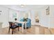 Bright living room with hardwood floors, blue accent chairs, and a view of the backyard at 7210 S Sparkman St, Tampa, FL 33616