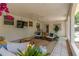 Inviting covered patio features a ceiling fan, television, seating, and plants at 7210 S Sparkman St, Tampa, FL 33616
