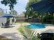 Inviting pool with ample seating surrounded by lush greenery and featuring shade umbrellas at 7210 S Sparkman St, Tampa, FL 33616