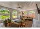 Inviting sunroom featuring vaulted ceilings, tiled floors, and backyard views at 7210 S Sparkman St, Tampa, FL 33616