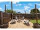 Backyard with a gravel fire pit and grey Adirondack chairs underneath string lights at 8339 75Th Ave, Seminole, FL 33777