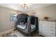 Cozy bedroom has wood floors, a window, and a white dresser at 8339 75Th Ave, Seminole, FL 33777