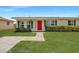 Charming single-story home with a well-manicured lawn and vibrant red door, offering a welcoming curb appeal at 8339 75Th Ave, Seminole, FL 33777