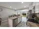 Open-concept kitchen showcasing a kitchen island with stainless steel appliances and backyard access at 8339 75Th Ave, Seminole, FL 33777