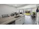 Bright kitchen with a kitchen island featuring a stainless steel sink and backyard view at 8339 75Th Ave, Seminole, FL 33777