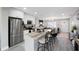 Contemporary kitchen offering an island with seating, stainless steel fridge, and open living area at 8339 75Th Ave, Seminole, FL 33777