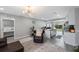 Open-concept living room adjacent to the kitchen featuring modern floors and ample natural light at 8339 75Th Ave, Seminole, FL 33777