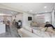 Open living area featuring a sofa, lounge chair, and seamless flow to the kitchen area at 8339 75Th Ave, Seminole, FL 33777