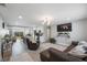 Open-concept living room with modern lighting, wood-look floors, and easy access to the kitchen at 8339 75Th Ave, Seminole, FL 33777
