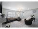 Cozy living room featuring wood-look floors, a comfortable leather sofa, and ample natural light at 8339 75Th Ave, Seminole, FL 33777