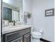 Stylish bathroom with a dark vanity and hanging plant decor at 9827 Sorbonne Loop, Seffner, FL 33584