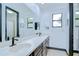 Well-lit bathroom features double sinks, a large mirror, ample storage, and modern fixtures at 9827 Sorbonne Loop, Seffner, FL 33584