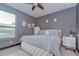 Cozy bedroom with a modern ceiling fan, dresser and a window at 9827 Sorbonne Loop, Seffner, FL 33584