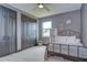 This gray bedroom offers carpet, a ceiling fan, a bed, and closet at 9827 Sorbonne Loop, Seffner, FL 33584