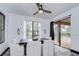 Bright dining area with a modern ceiling fan and sliding doors to the outdoor pool area at 9827 Sorbonne Loop, Seffner, FL 33584
