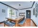 Dining room featuring a long wooden table, modern light fixture and built-in bar area at 9827 Sorbonne Loop, Seffner, FL 33584