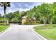 Gated community entrance with a charming guardhouse and well-manicured landscaping at 9827 Sorbonne Loop, Seffner, FL 33584