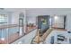 Bright foyer with hardwood floors, modern iron railing, and open view to other living spaces at 9827 Sorbonne Loop, Seffner, FL 33584