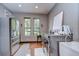 Spacious laundry room with modern appliances, wood floors, and natural light at 9827 Sorbonne Loop, Seffner, FL 33584