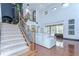 Grand living room featuring a staircase, high ceilings, and hardwood floors at 9827 Sorbonne Loop, Seffner, FL 33584