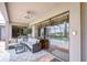Covered patio with outdoor seating area, adjacent to the pool and sliding glass doors at 9827 Sorbonne Loop, Seffner, FL 33584