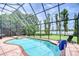 Beautiful screened pool area, hot tub and backyard overlooking the water at 9827 Sorbonne Loop, Seffner, FL 33584