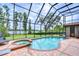 Enclosed pool area with views of the adjacent lake at 9827 Sorbonne Loop, Seffner, FL 33584