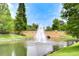 Picturesque water feature with a fountain and bridge, surrounded by lush landscaping and trees at 9827 Sorbonne Loop, Seffner, FL 33584