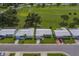 Aerial view of well-maintained single-story homes next to a lush green golf course under a sunny sky, showcasing community at 10005 41St N St, Pinellas Park, FL 33782